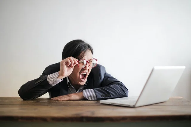 Shocked MBBS student looking at laptop.